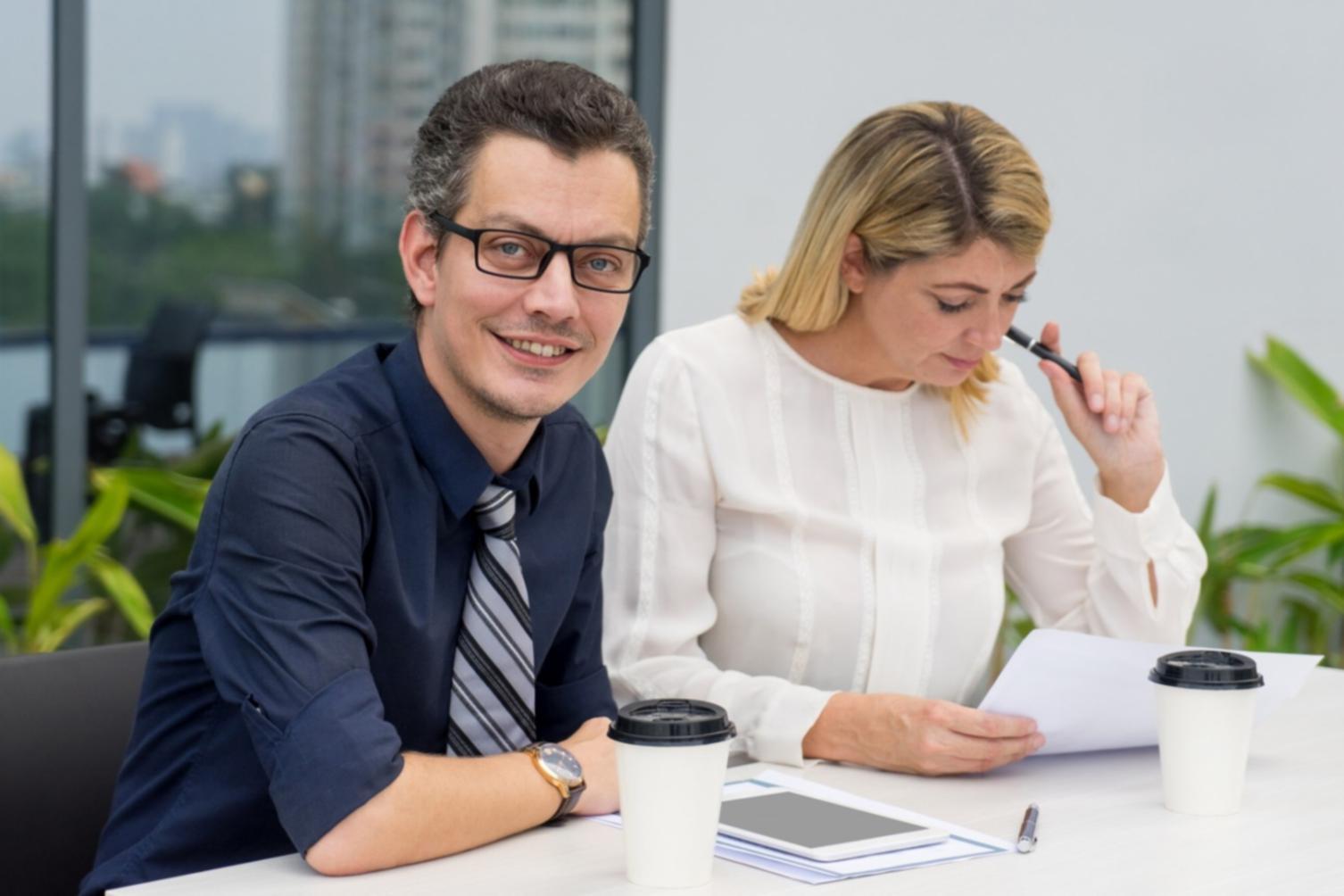 Financial planning session with charts and calculator showing practical money management techniques